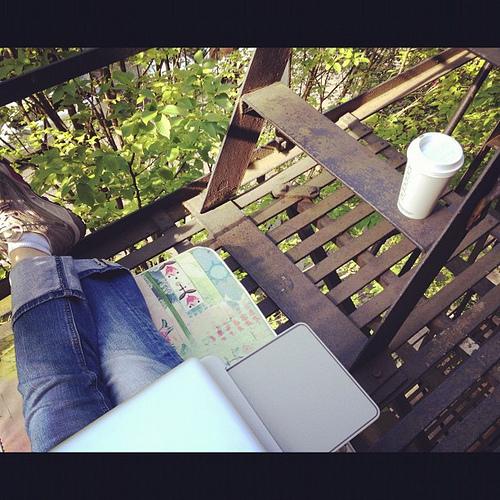 Writing in the fire escape. Gorgeous out here. City chatter below.