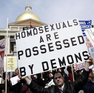 GAY MARRIAGE OPPONENT HOLDS SIGN IN PROTEST OUTSIDE STATEHOUSE