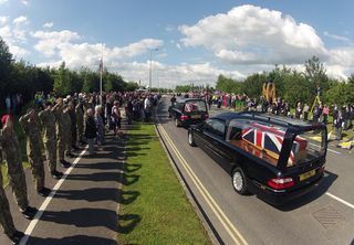 AY89097401Mourners join fri