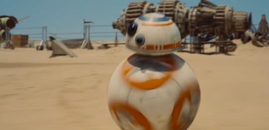 A rolling droid that appears to be part soccer ball part R2D2 head rolls through the sand