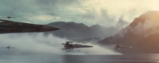 A group of X-wing fighters fly over a misty lake with snow covered mountains in the background
