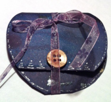 Heart card tied with a ribbon to hold it closed.