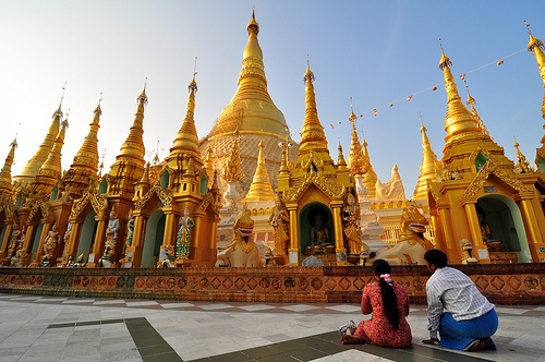 Praying couple at Shwedagon Pagoda in Yangon, Myanmar