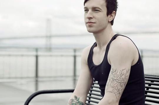 Person sitting on bench with bridge in background