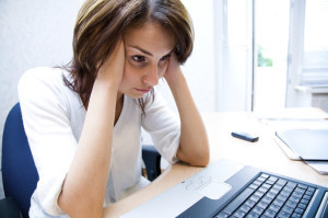 Woman thinks to notebook