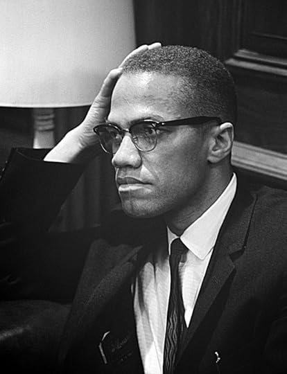 Malcolm X waiting for a press conference to begin on March 26, 1964. Public domain via Wikimedia Commons.