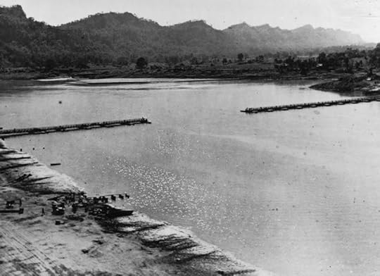 The 1,154-ft ft bridge across the Chindwin River in Burma as it neared completion; this would be the longest Bailey Bridge ever. 2 December 1944. (Imperial War Museum)