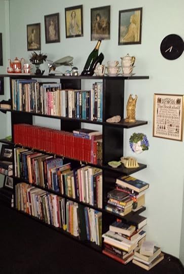 full bookcase with one entire shelf of red books