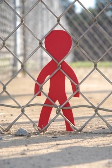 cutout figure behind barbed wire