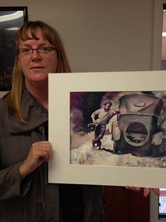 Colleen and the painting of her grandpa.