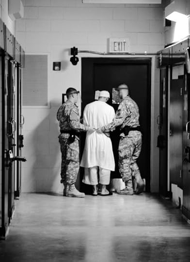 Guards from Camp 5 at Joint Task Force Guantanamo escort a detainee from his cell to a recreational facility within the camp. 