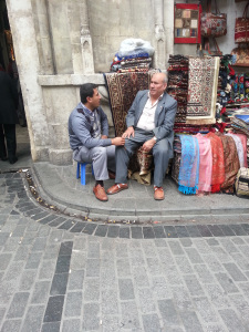 HOW BAZAAR Two vendors at the Grand Bazaar take a moment's break. A young boy bearing a tea tray soon served them refreshments right there on the pavement