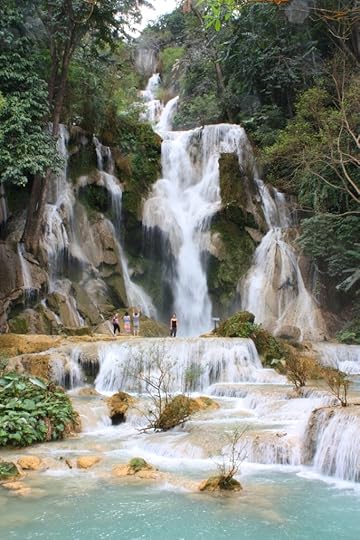Melanie stands in front of Kuang Si Falls in Laos 