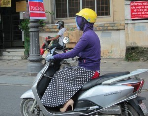 Determined not to get sun damage: mask, hoodie, gloves, apron and... stilettos