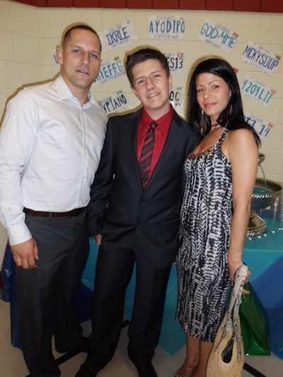 Thomas with his birth parents at his grade 8 graduation