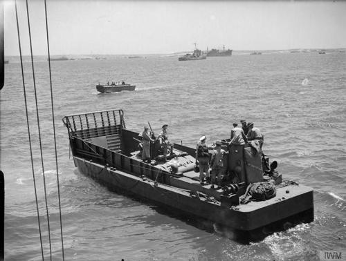 This photograph on the morning of the assault was taken by Lt H.A. Mason, R.N., an official Navy photographer, and shows an LCM (Landing Craft Mechanised), Mark 3. This is the first of a sequence of photos that Mason took beginning on HMS Hilary, the Force V HQ ship, and ending with him on shore. It was taken off 'Bark West' where the only LCM carrier was Empire Elaine, so this LCM had very probably been hoisted off her shortly before the picture was taken (Admiralty Official Collection, Imperial War Museum A 17955).