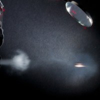A BB being fired out of an air gun. The flash was triggered as the BB broke the laser circuit
