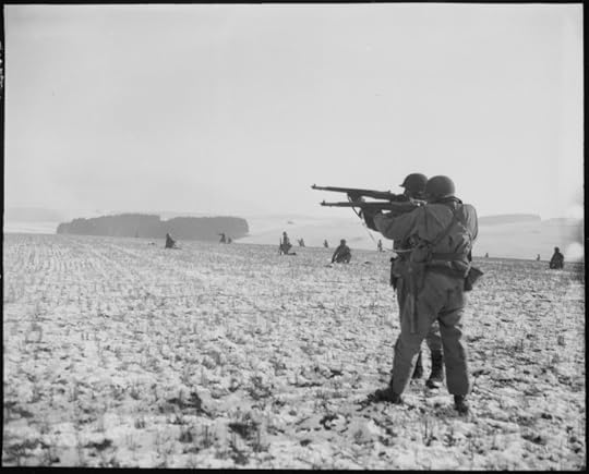 Infantrymen, attached to the 4th Armored Division, fire at German troops, in the American advance to relieve the pressure on surrounded airborne troops in Bastogne, Belgium. Department of Defense. Department of the Army. Office of the Chief Signal Officer. U.S. National Archives and Records Administration.
