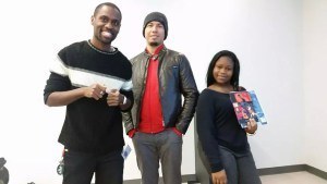 Flowered Concrete poses for a quick photo op with a young teen by the name of Shanelle who attended a three week poetry session by Founder/Author of FC, Kevin Anglade (left) as she received a copy of his novel and artwork posters designed by Alton Taylor (right).