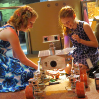 Camille and Genevieve with one of the Mars rovers they developed for NYSCI.