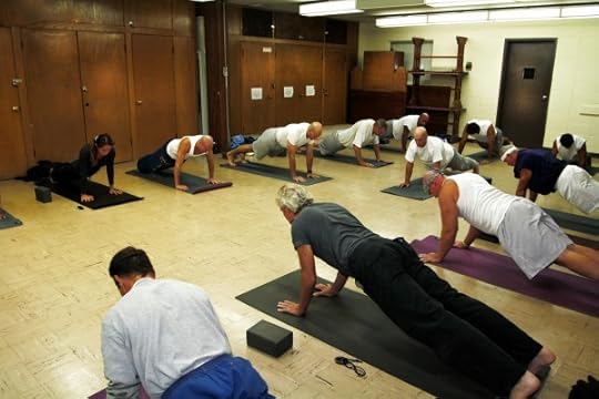 Founder and Director of the Prison Yoga Project James Fox leads students through the uttihita chaturanga danda asana (plank posture) in 2012 at San Quentin State Prison in San Quentin, California. Photographed by Robert Sturman. (Courtesy of Robert Sturman.)