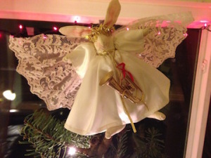 Delicate wings and a flowing gown surround a sweet-faced angel bunny topping Madeleine Robins' holiday tree.