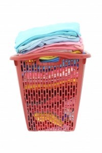 Old clothes in red hamper by keerati