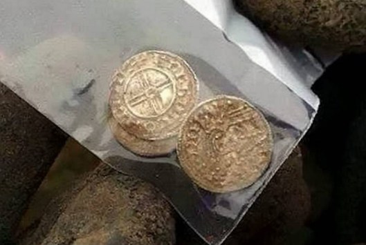 Members of the Weekend Wanderers Detecting Club work to uncover an inredible hoard of silver Anglo Saxon coins worth more than £1 million. See MASONS story MNCOINS: A hoard of rare Anglo Saxon coins worth more than £1 million has been found in a farmer's field by amateur treasure hunters. The stunning discovery is one of the most significant finds in Britain in recent years. The coins - over 1,000 years old - were unearthed during a Christmas dig organised by the Weekend Wanderers Detecting Club in rural farmland near Aylesbury, Bucks. Over 100 people turned out to take part in the festive hunt and they were stunned to find the collection of more than 5,000 silver coins.