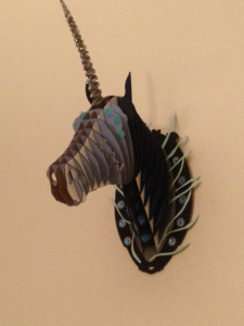 This is my unicorn head that is hanging over my fireplace. I don't have a name for him yet, but I'm leaning toward Reginald von Sparklenstein.