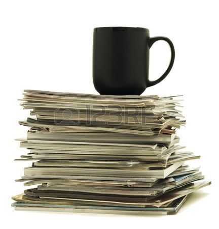 6786281-black-mug-sitting-on-top-of-a-stack-of-magazines.jpg