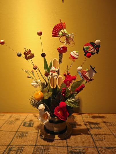 This is a little version of a kadomatsu, with bamboo, plum blossoms & pine all bundled up together with rice straw bring a triple whammy of long life, piles of wealth, and everlasting faithfulness to the house.