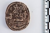 The amulet has several images on the side opposite the inscription.