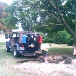 My son Shea and I cutting up a tree after it was struck by lightning