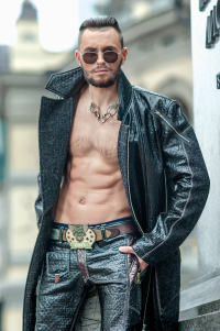 Scary yet fit biker guy with way cool long leather coat. And check out that belt buckle!