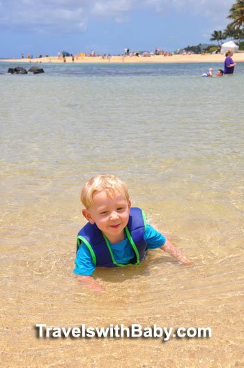 Toddler in water at Poipu Beach Park in Kauai, Hawaii