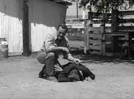 Chester Conklin (dead on ground) in The Beast With a Million Eyes.
