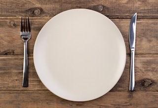 Empty plate on wooden background