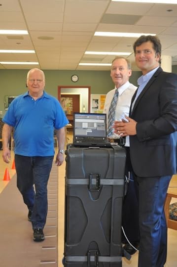 Drs. Michael Borrie (middle) and Manuel Montero-Odasso (right) performing a gait assessment of the data about gait speed and variability.