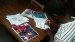 Kevin Eleven signing autographs for book winners.