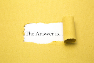Torn brown paper with The Answer is... text