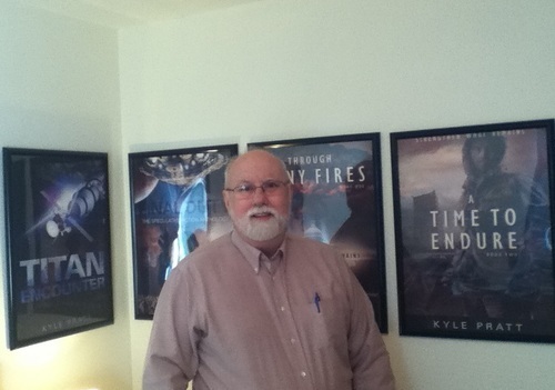 Kyle Pratt with posters of his first four books.