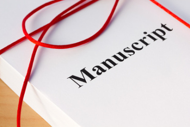 Stack of typing paper tied up with red ribbon, the word Manuscript in bold across the first page