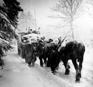 Troops of US 82nd Airborne Division marching behind M4 Sherman tank in a snowstorm toward German occupied town of Herresbach, Belgium, 28 Jan 1945. (US Army)