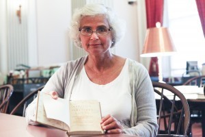 Anna Bryan holds the book she discovered in the Law Library's rare-book collections. Photo by Amanda Reynolds.