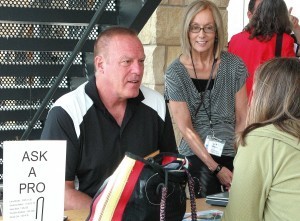 Me and Larry Brooks at last year's conference chatting with a writer on her project.