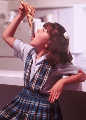 Catholic school girl eating pizza
