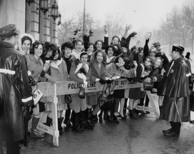 Fans line the streets to get a look at the Beatles following their arrival in NYC February 1964.