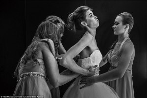 24A9A23400000578-2908028-A_bride_is_helped_into_her_tight_fitting_dress_by_her_bridesmaid-a-37_1421200477366