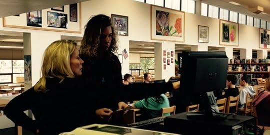 Teacher-Librarian Julie Burckhard assists Evan with a scan.