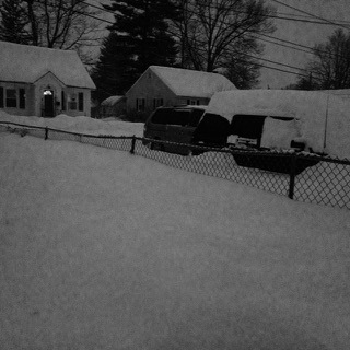 The snow has almost reached the top of the fence